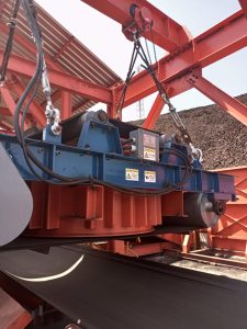 Pengantar [ WA 081227017677 – Magnetic Separator Industri Kapur ] Industri kapur (kalsium karbonat/CaCO3) adalah sektor fundamental yang mendukung berbagai aplikasi, mulai dari konstruksi, pertanian, hingga pengolahan air dan metalurgi. Kualitas kapur sangat bergantung pada kemurniannya, dan bahkan kontaminasi logam sekecil apa pun dapat berdampak serius pada proses di hilir dan kualitas produk akhir. Bahan baku kapur, umumnya batu gamping, ditambang dan diproses secara masif menggunakan conveyor belt system dan peralatan berat seperti crusher dan grinding mill. Sepanjang jalur pemrosesan yang panjang ini, kontaminasi oleh ferrous metal (besi, baja, atau tramp iron) adalah risiko yang tak terhindarkan. Kontaminasi ini bisa berasal dari keausan mesin, potongan alat kerja, atau material asing dari area tambang. Di sinilah peran magnetic separator industri kapur menjadi krusial. Alat ini berfungsi sebagai pemisah logam di conveyor yang sangat efisien, menjamin perlindungan peralatan pertambangan yang mahal dan meningkatkan kemurnian produk kapur. Investasi pada magnetic separator conveyor bukan sekadar biaya, melainkan strategi mutlak untuk mencapai efisiensi tinggi dalam pemrosesan material pertambangan dan menjaga keamanan operasi pertambangan. Artikel teknis ini akan mengupas tuntas prinsip kerja, aplikasi industri, jenis magnetic separator, dan manfaat teknologi magnetic separator industri kapur dalam mencapai keunggulan operasional. ## 1. Prinsip Kerja Magnetic Separator Inti dari sistem pemisahan logam yang efektif adalah pemanfaatan gaya magnet untuk menarik material feromagnetik dari aliran material non-magnetik. Proses ini dikenal sebagai magnetic material handling. ### 1.1. Konsep Gaya Tarik Magnetik pada Kontaminan Sebuah mesin pemisah besi atau magnetic separator menghasilkan medan magnet yang kuat, diukur dalam magnetic field intensity (Gauss atau Tesla). Ketika material kapur mentah yang bergerak cepat di atas conveyor belt memasuki zona medan magnet ini, setiap kontaminan logam akan dikenai gaya tarik magnet. Kekuatan gaya tarik harus dirancang untuk mengatasi gaya gravitasi dan momentum material yang dibawa oleh conveyor. Pemilihan Magnet: Jenis magnetic separator yang digunakan sangat menentukan intensitas medan. Banyak magnetic separator conveyor modern menggunakan rare earth magnet (seperti neodymium magnet) karena kemampuannya menghasilkan medan yang sangat kuat, ideal untuk menarik partikel halus atau yang tertanam dalam lapisan material yang tebal. Efisiensi Pemisahan: Tingkat pemisahan logam yang optimal tercapai ketika magnet diposisikan pada jarak yang tepat (disebut working gap) dari permukaan conveyor belt, memastikan penetrasi medan ke seluruh lapisan material curah kapur. Prinsip kerja magnetic separator ini memungkinkan ekstraksi logam dari conveyor secara berkelanjutan dan otomatis, menjadi solusi pemisahan logam yang handal. ## 2. Klasifikasi dan Jenis Magnetic Separator untuk Aplikasi Kapur Pemilihan types of magnetic separator harus disesuaikan dengan kapasitas material, ukuran material (granulometri), dan kondisi lingkungan di pabrik kapur. ### 2.1. Overband Magnetic Separator (Suspended Magnet) Jenis ini, sering disebut suspended magnetic separator atau overband magnetic separator, adalah pilihan utama untuk aplikasi industri berat pada jalur conveyor belt system utama. Fungsi: Unit magnetik ini digantung melintang atau sejajar di atas konveyor utama. Ia menarik kontaminan magnetik ke atas, menjauhkannya dari aliran kapur. Keunggulan Self-Cleaning: Model self-cleaning overband magnetic separator dilengkapi dengan sabuk sekunder yang berputar mengelilingi inti magnet. Sabuk ini membawa logam yang telah tertarik menjauh dan membuangnya ke wadah scrap metal recovery, menjamin pembersihan otomatis dan kontinuitas pemrosesan material. Ini penting untuk operasi continuous pada alat pertambangan tahan lama. Aplikasi: Paling efektif untuk perlindungan crusher primer dan sekunder dari potongan besi besar (tramp iron). ### 2.2. Magnetic Pulley Magnetic pulley atau head pulley magnet adalah magnetic separator yang diposisikan di ujung pelepasan (discharge end) konveyor. Fungsi: Katrol ujung diganti dengan magnetic pulley permanen. Ketika material kapur mencapai ujung konveyor, material non-magnetik akan jatuh bebas, mengikuti lintasan normal. Sebaliknya, kontaminan magnetik akan tetap “terjebak” pada sabuk hingga ia melewati bagian bawah katrol, di mana ia kemudian jatuh ke wadah terpisah. Aplikasi: Ideal untuk pemisahan material di ujung konveyor, efektif menangkap logam yang lebih kecil dan halus, melengkapi perlindungan yang diberikan oleh suspended magnet. ### 2.3. Drum Magnetic Separator dan Separator Basah Untuk proses kapur yang melibatkan material halus atau slurry (bubur), seperti dalam proses pengolahan air: Drum Magnetic Separator: Digunakan untuk material kapur yang mengalir bebas atau untuk pemisahan mineral halus dalam volume tinggi. Logam tertarik ke drum yang berputar dan dibuang. Wet Magnetic Separation: Digunakan untuk pemisahan basah material yang dicampur cairan, penting untuk meningkatkan kemurnian produk kapur hasil filtrasi. ## 3. Manfaat Kunci Magnetic Separator Industri Kapur: Keamanan dan Kualitas Investasi pada magnetic separator berkualitas tinggi menghasilkan pengembalian yang cepat melalui pengurangan biaya perawatan dan peningkatan keuntungan dari kualitas produk. ### 3.1. Perlindungan Aset dan Pengurangan Waktu Henti Fungsi primer dari magnetic separator adalah perlindungan peralatan pertambangan. Kapur (CaCO3) dapat menjadi abrasif, dan benturan dengan kontaminan logam dapat menyebabkan kerusakan parah pada mesin mahal seperti crusher dan mill. Mengurangi Risiko: Dengan menghilangkan kontaminan logam secara proaktif, magnetic separator secara dramatis memperpanjang umur pakai komponen penting, mengurangi kerusakan mesin mahal, dan meminimalkan biaya penggantian suku cadang. Peningkatan Ketersediaan: Pengurangan waktu henti (downtime) yang tidak terencana akibat kerusakan berarti efisiensi produksi yang lebih tinggi dan kontinuitas pemrosesan material yang terjamin. Ini merupakan kunci keamanan kerja dan keselamatan kerja di area pengolahan. ### 3.2. Peningkatan Mutu dan Nilai Jual Produk Kapur Kemurnian produk adalah penentu nilai jual kapur. Logam yang tersisa dalam kapur dapat menyebabkan masalah serius di aplikasi hilir (misalnya, staining atau clogging). Standar Kualitas: Sistem pemisahan logam yang efektif menjamin kapur memenuhi standar kualitas industri yang ketat, meningkatkan nilai tambah material dan membuka peluang pasar yang lebih premium. Pembersihan Material Curah: Pembersihan mineral yang efisien oleh separator magnetik sangat penting sebelum material masuk ke calciner (kiln), karena logam dapat merusak lapisan kiln atau bereaksi pada suhu tinggi. ## 4. Faktor Penentu Pemilihan Magnetic Separator yang Optimal Pemilihan alat pertambangan yang tepat memerlukan pertimbangan teknis yang detail, bukan sekadar membeli magnet terkuat. ### 4.1. Analisis Karakteristik Material dan Kapasitas Kapasitas Material (TPH): Kapasitas produksi (ton per hour) yang tinggi memerlukan magnet dengan jangkauan dan kekuatan yang lebih besar. Perlu dipertimbangkan ukuran magnet, lebar conveyor belt, dan kecepatan conveyor. Kedalaman Lapisan: Semakin tebal lapisan kapur di atas conveyor, semakin kuat magnetic field intensity yang dibutuhkan. Untuk lapisan tebal, electromagnetic separator sering menjadi pilihan karena kekuatan medan magnetnya dapat diatur (pengaturan medan magnet) dan lebih dalam penetrasinya. Ukuran Kontaminan: Jika kontaminan cenderung besar dan kasar (tramp iron), permanent magnet separator berintensitas tinggi seperti overband magnetic separator dengan neodymium magnet mungkin sudah mencukupi. Jika targetnya adalah serpihan kecil (disebut pemisahan partikel halus), kombinasi suspended magnet dan magnetic pulley mungkin diperlukan. ### 4.2. Perbandingan Magnet Permanen vs. Elektromagnetik Magnet Permanen: Handal, rendah biaya perawatan, tidak memerlukan daya listrik. Contoh: magnetic pulley dan sebagian suspended magnet. Magnet Elektromagnetik: Kekuatan magnet dapat disesuaikan, ideal untuk material yang bervariasi. Cocok untuk aplikasi industri dengan volume material sangat tinggi atau pemisahan magnetik tingkat tinggi. Membutuhkan cooling system untuk menjaga suhu kumparan agar tetap efektif dan efisien. ## 5. Optimalisasi Pemasangan dan Desain Heavy Duty Pemasangan yang tepat dan desain heavy duty magnetic separator ### 5.1. Lokasi Strategis di Jalur Conveyor Lokasi pemasangan conveyor magnetic separator harus diputuskan berdasarkan tujuan pemisahan: Pemisahan Primer: Di conveyor setelah primary crusher untuk menangkap besi besar, tujuannya adalah perlindungan crusher sekunder. Pemisahan Sekunder: Sebelum pulverizer atau mill, untuk menghilangkan partikel halus dan memastikan kemurnian produk tertinggi. Desain magnetic material handling harus mempertimbangkan sudut kemiringan konveyor dan titik jatuh material untuk memaksimalkan gaya tarik. ### 5.2. Desain Industrial Grade dan Keandalan Lingkungan pabrik kapur sangat berdebu dan abrasif. Oleh karena itu, peralatan harus memiliki peralatan magnetik industrial grade dengan konstruksi yang kuat, tahan debu, dan tahan getaran. Magnetic separation equipment manufacturer yang baik akan menyediakan unit dengan housing tertutup dan sealing berkualitas untuk menjaga magnet dari lingkungan luar, memastikan keandalan operasional dan efisiensi pemisahan yang konsisten. ## 6. Teknologi Mutakhir dan Peningkatan Recovery Inovasi terus mendorong batas pemisahan magnetik, terutama dalam konteks pertambangan berkelanjutan dan recovery sumber daya. ### 6.1. Penggunaan High-Intensity Magnetic Separation (HIMS) Untuk pemisahan mineral non-ferrous yang mungkin sedikit bersifat paramagnetik atau untuk pembersihan kapur yang sangat halus, teknologi HIMS memainkan peran. Meskipun kapur adalah material utama, HIMS dapat digunakan pada tailing atau material sampingan untuk ekstraksi bijih atau mineral lain, meningkatkan recovery rate fasilitas. ### 6.2. Automasi dan Monitoring Sistem modern dilengkapi dengan sensor dan sistem kontrol otomatis yang memantau tingkat kontaminan magnetik yang terkumpul, memicu pembersihan otomatis, dan memberikan data real-time mengenai efektivitas pemisahan. Ini mempermudah pemeliharaan prediktif dan memastikan solusi pemisahan logam selalu bekerja pada puncak efisiensinya. ## 7. Dampak Magnetic Separator pada Biaya Operasional Sebuah pabrik kapur besar yang mengabaikan penggunaan magnetic separator berkualitas tinggi mengalami rata-rata tiga kali kerusakan mesin mahal pada vertical mill per tahun. Setiap insiden memakan biaya penggantian suku cadang dan biaya perawatan sekitar $50.000 dan waktu henti 72 jam. Setelah menginstal self-cleaning overband magnetic separator dan magnetic pulley di jalur conveyor belt system mereka, pabrik tersebut mencatat penurunan insiden kerusakan yang disebabkan logam hingga 95% dalam tahun pertama. Pengurangan biaya perawatan yang dicapai jauh melampaui harga investasi awal, membuktikan bahwa magnetic separator adalah investasi penting dalam efisiensi produksi dan perlindungan aset industri. ## 8. Cara Memilih Magnetic Separator Terbaik Memastikan kualitas dan kinerja jangka panjang. ### 8.1. Kualitas Magnetic Separator dan Dukungan Purna Jual Memilih magnetic separation equipment manufacturer yang memiliki sertifikasi produk dan reputasi baik adalah fundamental. Produk harus tahan terhadap getaran, debu, dan beban kerja berat 24/7. Calon pembeli harus mempertimbangkan garansi produk, ketersediaan suku cadang, dan konsultasi teknis dari produsen. ### 8.2. Biaya Perawatan Jangka Panjang Meskipun magnetic separator permanen memiliki biaya perawatan yang lebih rendah, electromagnetic separator yang dirancang dengan baik dengan sistem pendingin dan sealing yang efisien juga menawarkan keandalan tinggi dan pengaturan medan magnet yang fleksibel, memberikan fleksibilitas operasional yang tidak ditawarkan oleh magnet permanen. ## 9. Cara Menghindari Risiko dan Memaksimalkan Investasi Setiap langkah dalam pemrosesan material adalah potensi risiko tanpa proteksi magnetik. Analisis Risiko: Pemeliharaan pencegahan melalui magnetic separator adalah jauh lebih murah daripada perbaikan darurat. Nilai Tambah: Selain perlindungan, recovery scrap metal dari proses pemisahan dapat menjadi sumber pendapatan sampingan, atau minimal, mengurangi biaya penanganan material buangan. Penutup Magnetic separator conveyor adalah pahlawan tanpa tanda jasa dalam industri kapur dan industri pertambangan secara umum. Dengan memahami prinsip kerja, memilih jenis magnetic separator yang tepat—baik itu suspended magnet untuk tramp iron besar atau magnetic pulley untuk partikel kecil—dan mengintegrasikannya secara strategis, perusahaan dapat menjamin efisiensi pemisahan yang maksimal. Manfaat magnetic separator tidak hanya terlihat pada perlindungan mesin mahal, tetapi juga dalam peningkatan drastis kemurnian produk kapur, yang pada akhirnya meningkatkan daya saing di pasar. Tingkatkan Keamanan Produksi Anda dengan Magnetic Separator Bersertifikat dan Bergaransi. Jangan biarkan kontaminasi logam mengancam aset dan reputasi Anda. Hubungi kami hari ini untuk konsultasi mendalam mengenai solusi magnetic separator yang disesuaikan dengan kapasitas material spesifik pabrik kapur Anda, dan mulai nikmati efisiensi produksi dan keamanan operasi pertambangan yang optimal. Hubungi kami untuk konsultasi gratis dan temukan Magnetic Separator with Industry paling sesuai dengan kebutuhan industry Anda, PT. Masusskita United siap Membantu! Dengan menggunakan magnetic separator, khusus untuk produksi. Oleh karena itu, Kami sedia untuk memberikan informasi lebih lanjut dan konsultasi mengenai penggunaan magnetic separator, hubungi kami: No. HP : ( 024 ) 7651 0250 – 081227017677 ( WA ) Email : masusskita@gmail.com Website : PT. Masusskita United | | Metal Detector Food Grade | | Carousell | | Locanto Alamat : Komplek Ruko Permata Hijau Diamond No 2-4 Jl. MT Haryono No 16. Ungaran Barat, Kab. Semarang – Jawa Tengah 50511 Dengan memahami pentingnya WA 081227017677 – Jual Supply Magnetic Separator with Industry untuk Seluruh Indonesia. Perusahaan dapat mengambil langkah yang tepat untuk memastikan produk mereka aman dan berkualitas. Jangan ragu untuk berinvestasi dalam alat ini demi kebaikan bersama. Tags : jual magnetic separator conveyor, harga magnetic separator conveyor industry, distributor magnetic separator conveyor, beli magnetic separator conveyor industri, jual alat pemisah logam industry, jual mesin pemisah logam presisi, supplier magnetic separator conveyor, magnetic separator conveyor efisiensi tinggi, jual magnetic separator food grade industry, jual magnetic roller conveyor, mesin pemisah logam otomatis, sistem conveyor pemisah logam, magnetic separator industri tambang, magnetic separator untuk pabrik makanan, conveyor magnet permanen industry, teknologi pemisahan logam presisi, alat pemisah besi otomatis, conveyor magnet efisiensi tinggi, magnetic separator drum industry, magnetic conveyor untuk pengolahan material, pemisahan logam non-ferrous dan ferrous, sistem pemurnian bahan industry, conveyor dengan magnet kuat, deteksi dan pemisahan logam presisi, solusi pemurnian bahan produksi, efisiensi tinggi dalam pemrosesan material, peralatan magnetik industri modern, alat pemisah logam otomatis untuk produksi - 03 - Apa Manfaat Self Cleaning Magnetic Separator?Magnetic Separator Installations